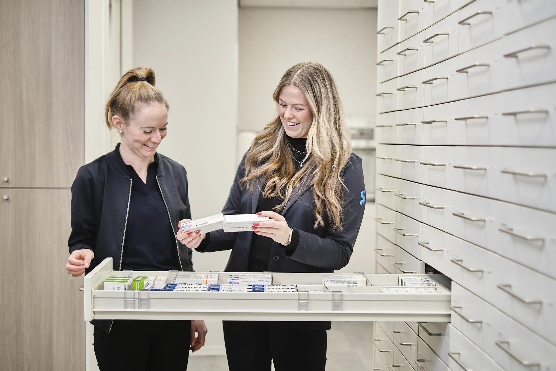 apothekersassistente staan bij medicijnenla